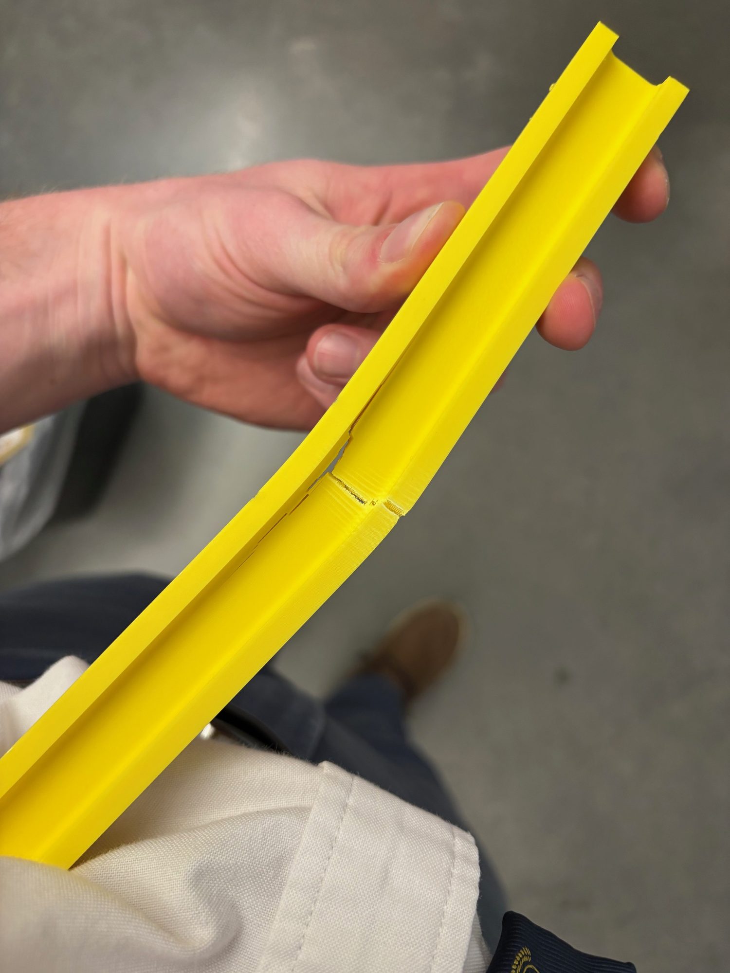 Yellow printed I-beam bent and cracked after load testing