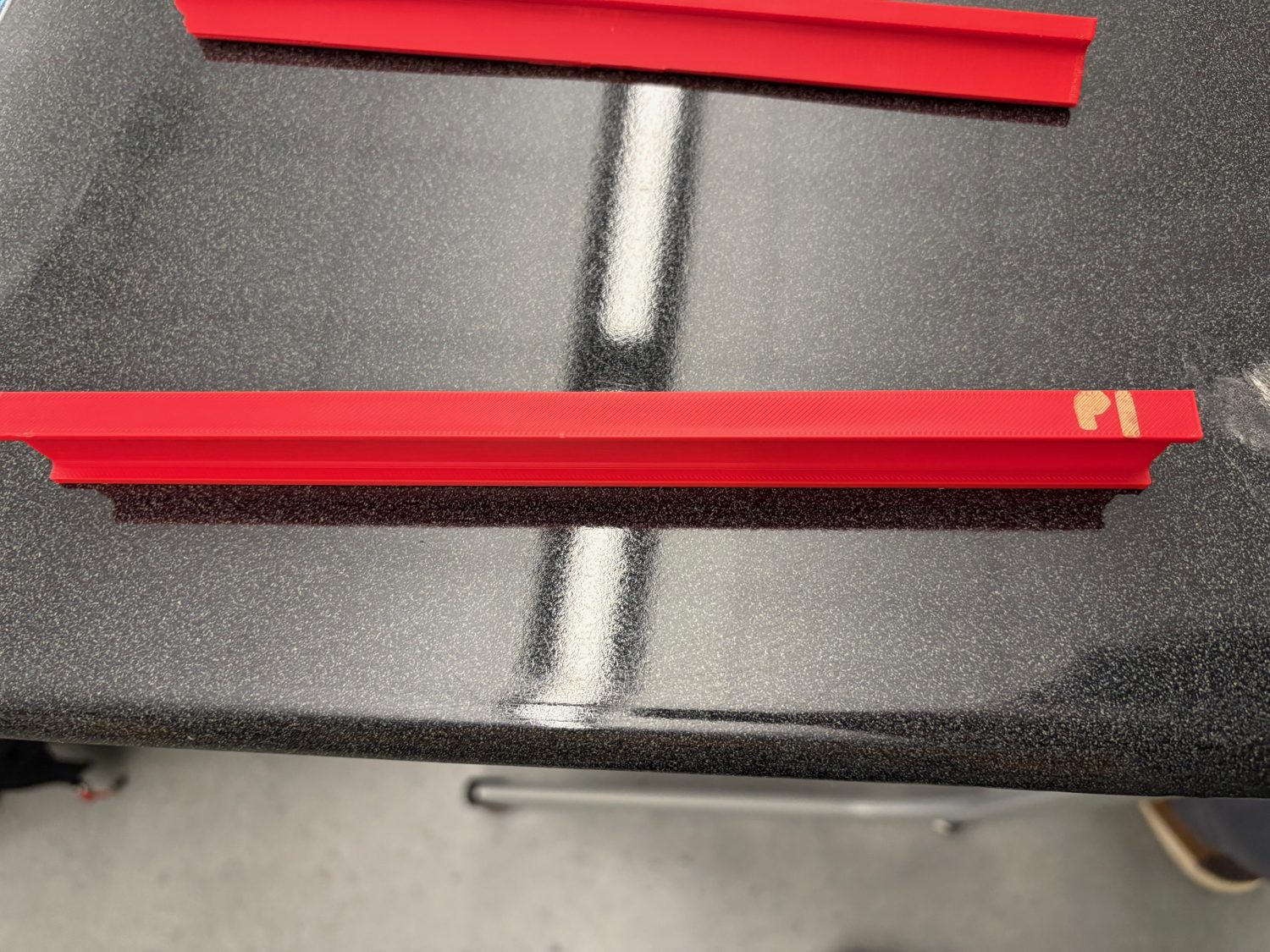 Printed red I-beam labeled P1 on a workbench