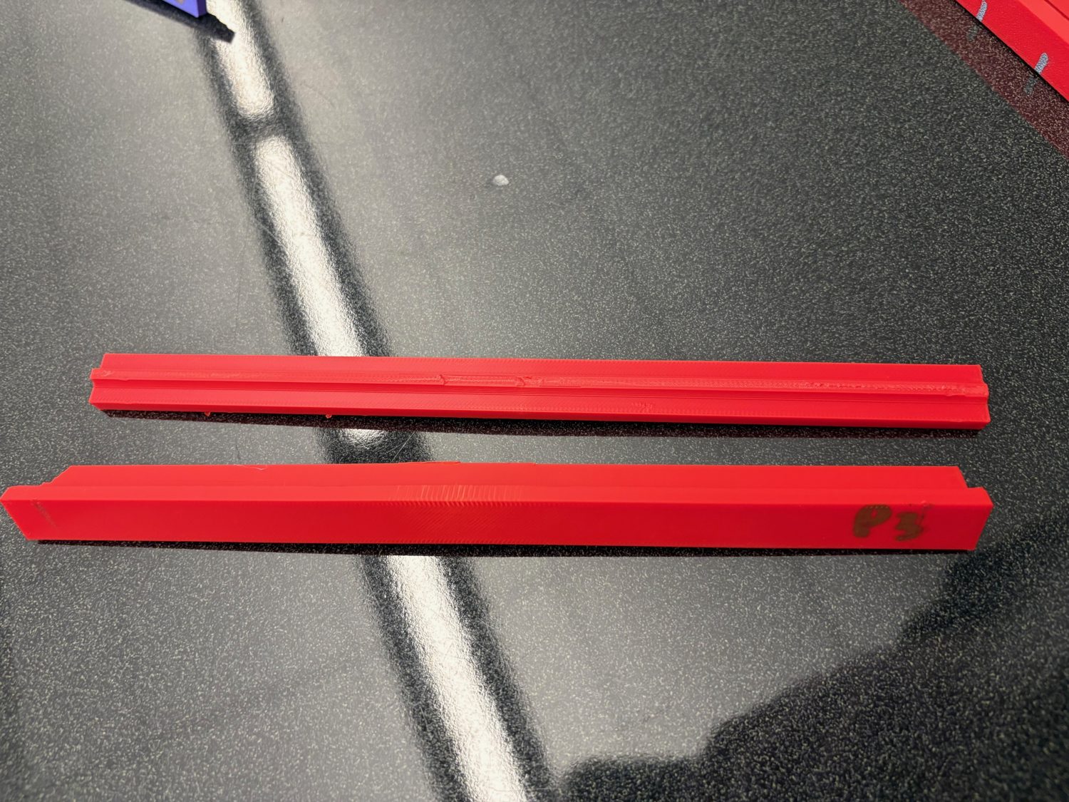 Two printed red I-beams labeled P3